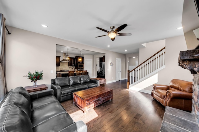 living room with ceiling fan and dark hardwood / wood-style flooring