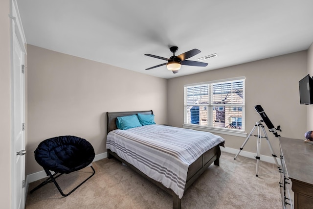 bedroom featuring ceiling fan and light carpet