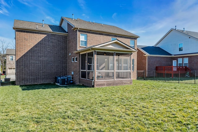 back of house with cooling unit, a yard, and a sunroom