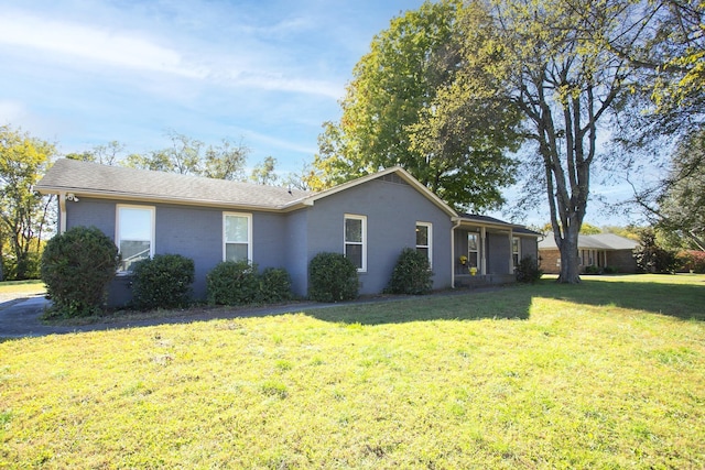 view of side of home with a lawn