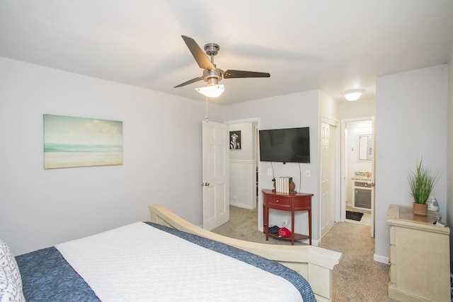 carpeted bedroom featuring connected bathroom and ceiling fan