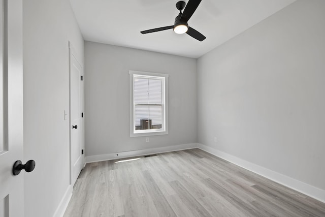 unfurnished room with light wood-type flooring, visible vents, ceiling fan, and baseboards