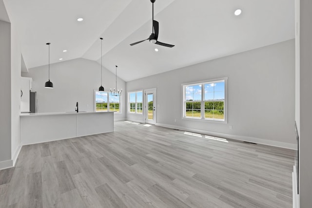 unfurnished living room with recessed lighting, light wood-style flooring, a sink, and ceiling fan with notable chandelier