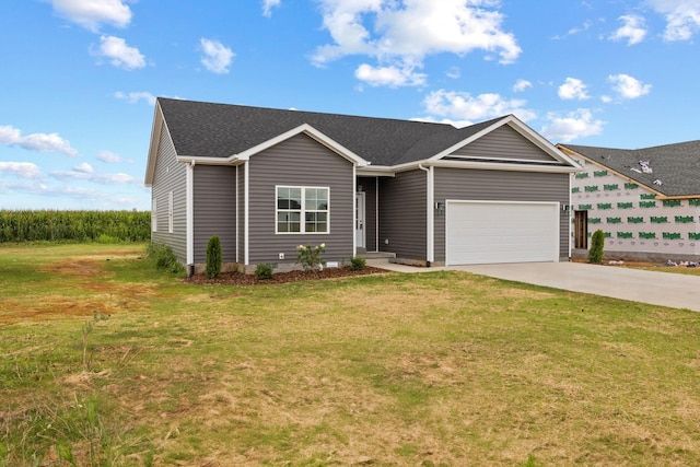 view of front of house featuring a garage, a shingled roof, a front lawn, and concrete driveway