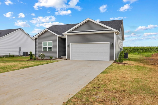 ranch-style home with central AC, a front lawn, an attached garage, and driveway