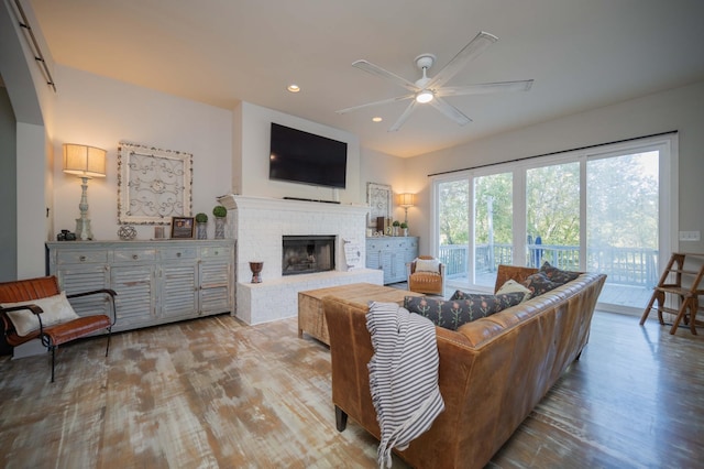 living area with recessed lighting, wood finished floors, a fireplace, and ceiling fan