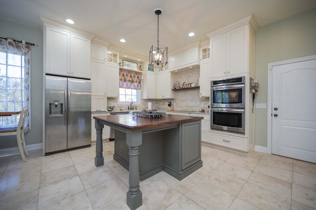 kitchen featuring backsplash, appliances with stainless steel finishes, white cabinets, wood counters, and open shelves