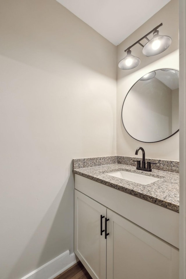 bathroom featuring vanity and hardwood / wood-style flooring