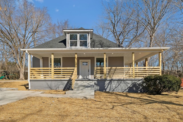 view of front of home with a porch and a shingled roof