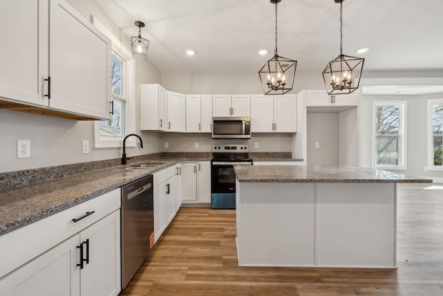 kitchen featuring white cabinetry, stainless steel appliances, and a center island