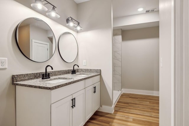 bathroom with vanity and hardwood / wood-style floors