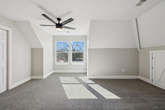 bonus room featuring dark colored carpet, vaulted ceiling, and ceiling fan