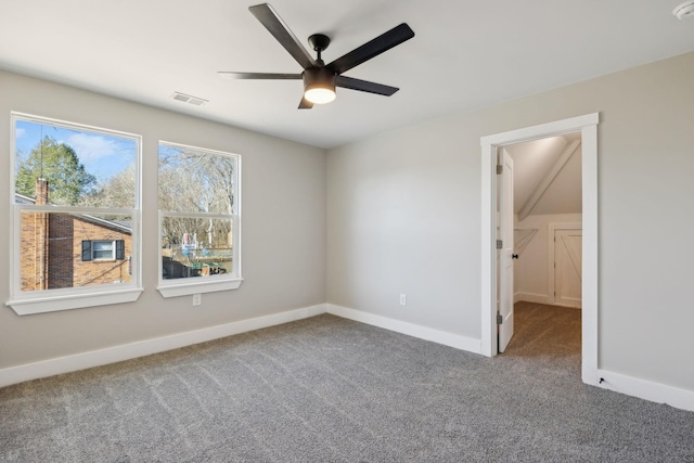 carpeted spare room with ceiling fan