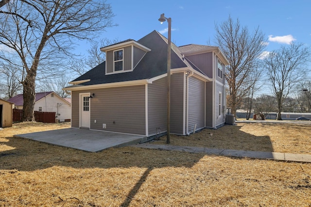 rear view of property with a yard, central AC, and a patio