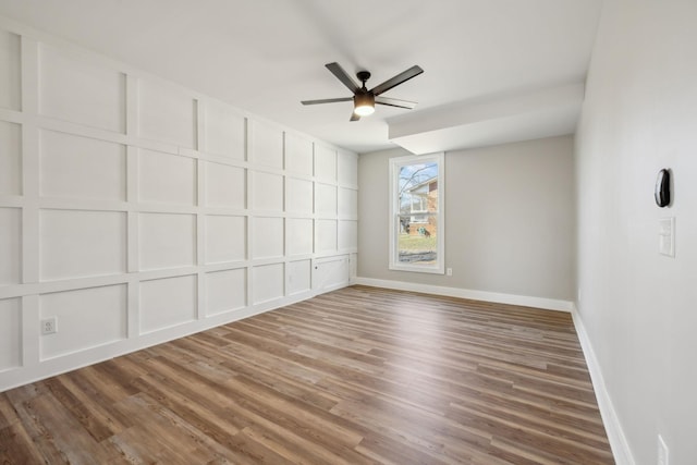 spare room with hardwood / wood-style floors and ceiling fan