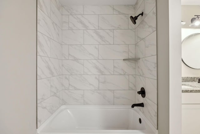 bathroom with vanity and tiled shower / bath combo