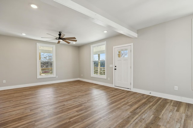 entrance foyer featuring ceiling fan, hardwood / wood-style floors, and beam ceiling