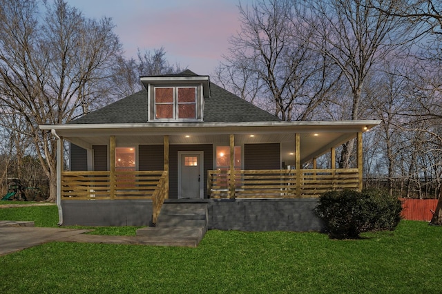 view of front of house with a lawn and a porch