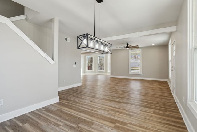 unfurnished living room with hardwood / wood-style floors and ceiling fan