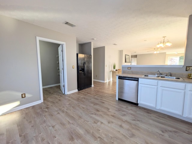 kitchen featuring dishwasher, sink, white cabinets, light wood-type flooring, and black refrigerator with ice dispenser