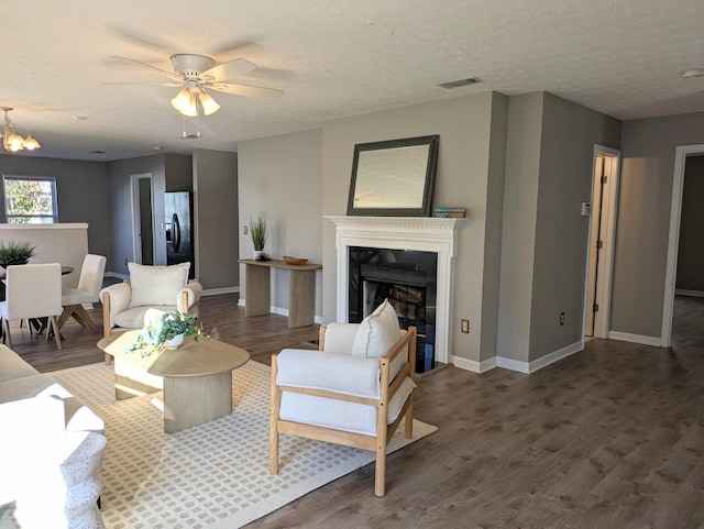 living room with dark hardwood / wood-style floors and a textured ceiling