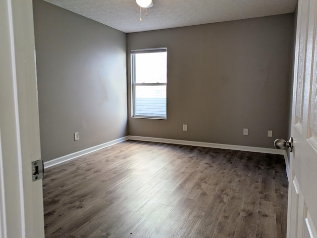 empty room featuring ceiling fan, wood-type flooring, and a textured ceiling