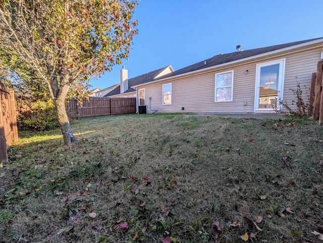 rear view of property featuring a yard