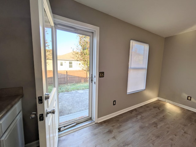 doorway to outside with light wood-type flooring