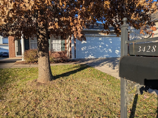 obstructed view of property with a garage and a front lawn