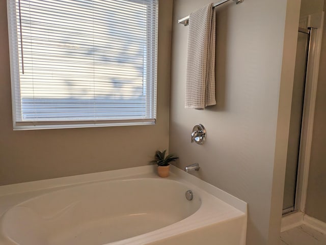 bathroom with independent shower and bath and plenty of natural light