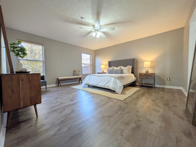 bedroom with hardwood / wood-style flooring and ceiling fan