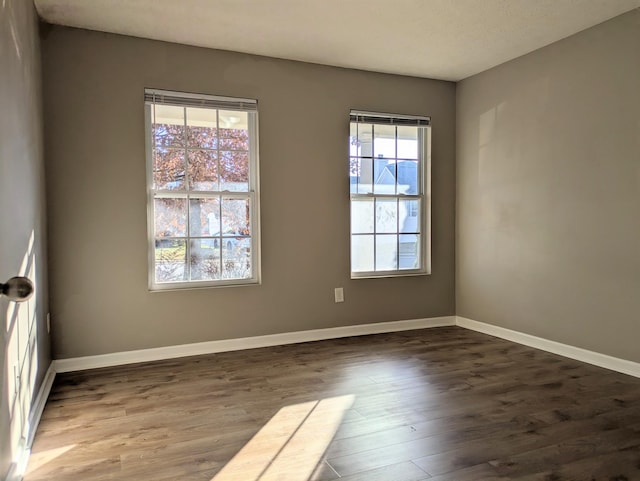 spare room featuring dark hardwood / wood-style floors