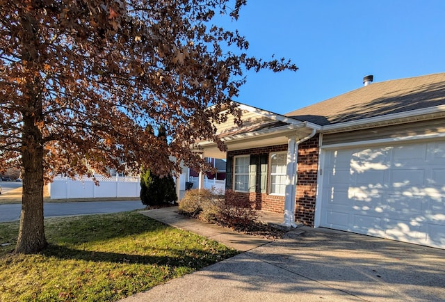 view of front of property featuring a garage and a front lawn