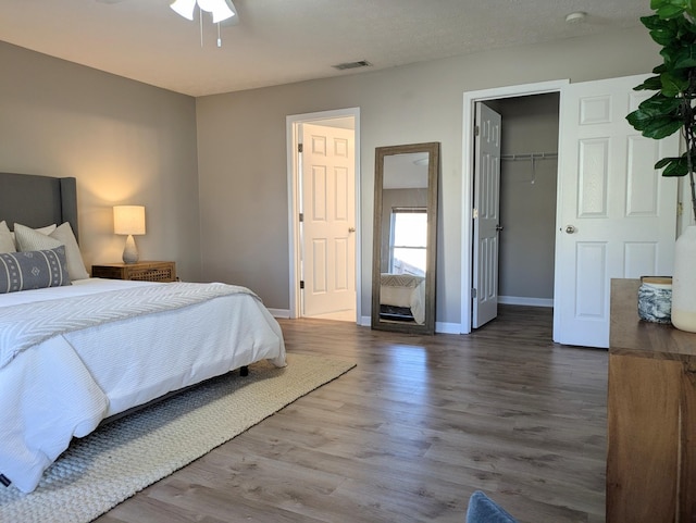 bedroom with wood-type flooring and a closet