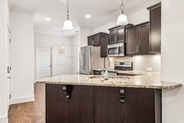 kitchen with sink, a breakfast bar area, decorative light fixtures, kitchen peninsula, and stainless steel appliances