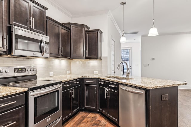 kitchen featuring sink, crown molding, dark wood-type flooring, appliances with stainless steel finishes, and decorative light fixtures