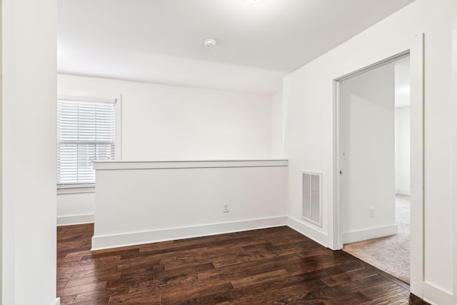 empty room with dark hardwood / wood-style floors