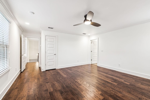 spare room with crown molding, dark wood-type flooring, and ceiling fan