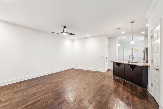 interior space with sink, dark wood-type flooring, ornamental molding, and ceiling fan