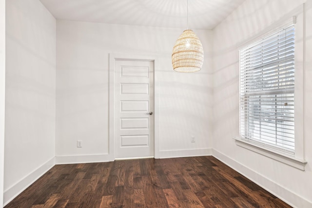 empty room with dark hardwood / wood-style flooring