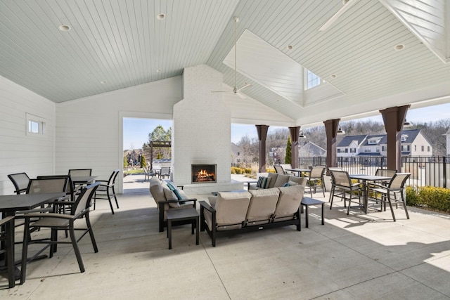 view of patio featuring an outdoor living space with a fireplace