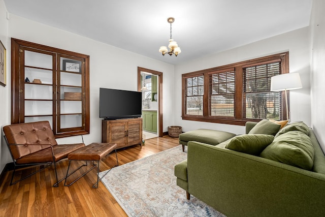 living room with hardwood / wood-style floors and a notable chandelier