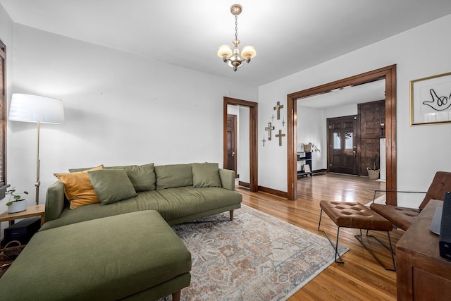 living room with a chandelier and light hardwood / wood-style flooring