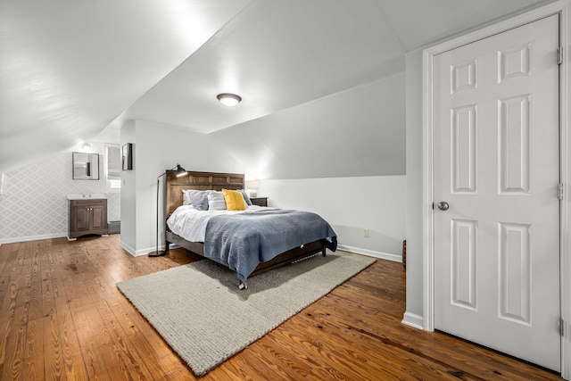 bedroom featuring wood-type flooring and vaulted ceiling