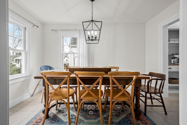 dining room featuring a wealth of natural light, a chandelier, and light tile patterned floors