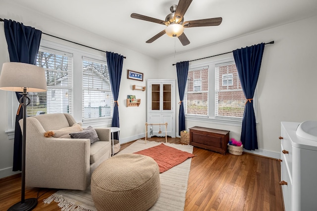 sitting room with sink, wood-type flooring, and ceiling fan