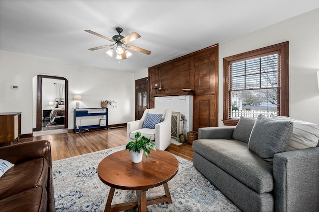 living room featuring light hardwood / wood-style floors and ceiling fan