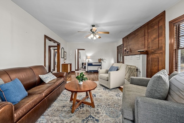 living room featuring ceiling fan and hardwood / wood-style floors