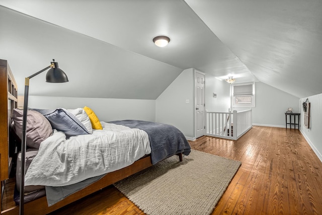 bedroom featuring vaulted ceiling and hardwood / wood-style floors