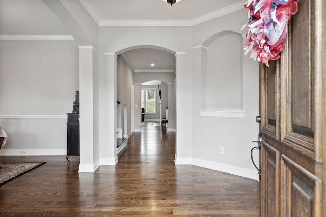 foyer entrance featuring ornamental molding and dark hardwood / wood-style floors